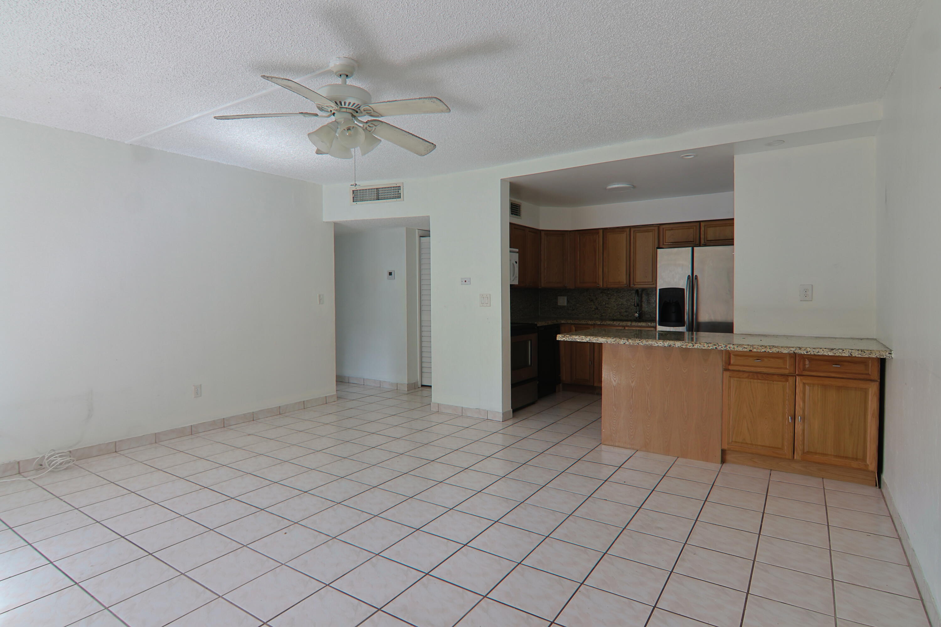9360 Southwest 87th Avenue, Unit N8 Miami, FL 33176 - Photo 3 of 15 a view of a kitchen with a sink and cabinets