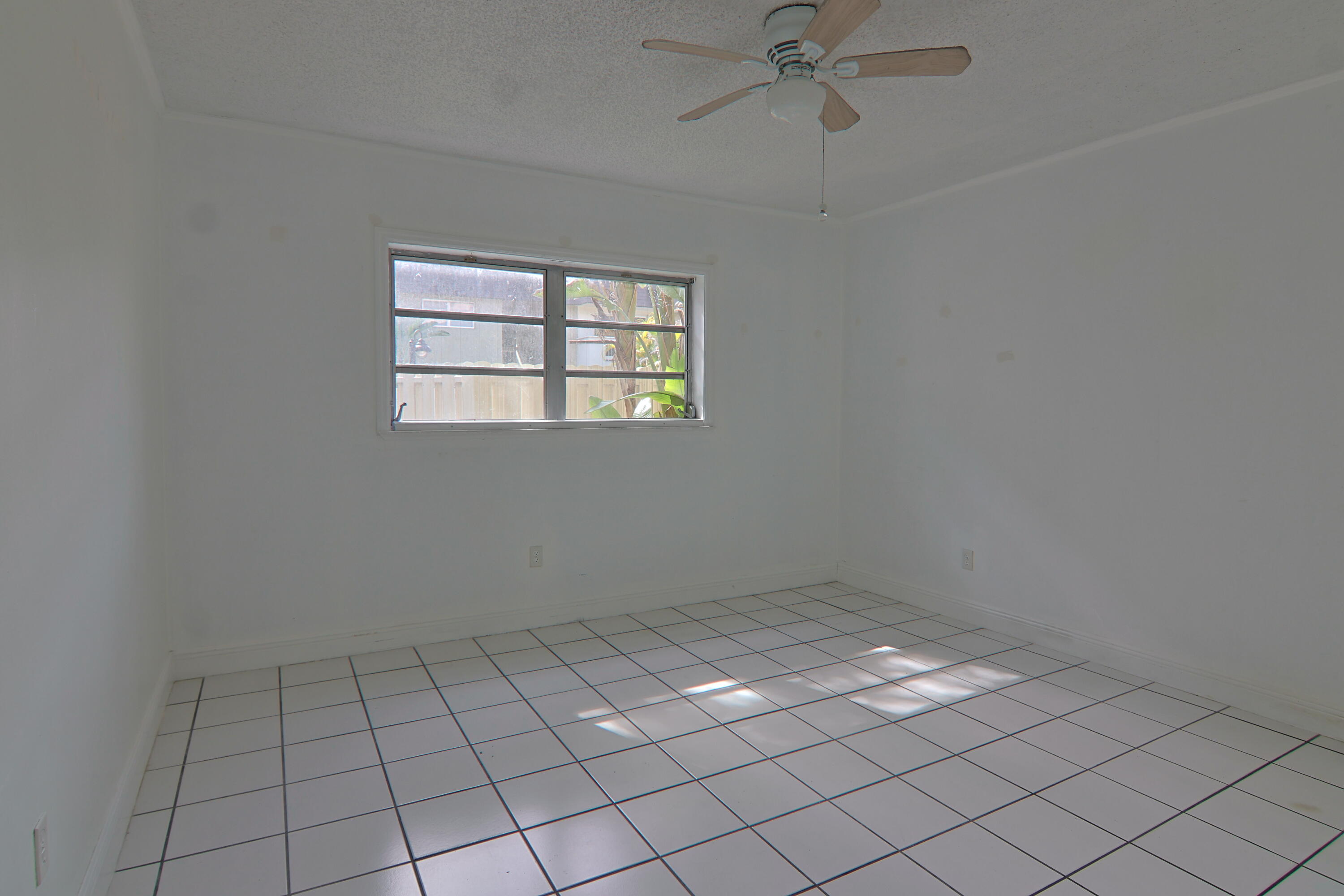9360 Southwest 87th Avenue, Unit N8 Miami, FL 33176 - Photo 5 of 15 a view of an empty room and window