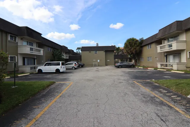 a car parked in front of white building