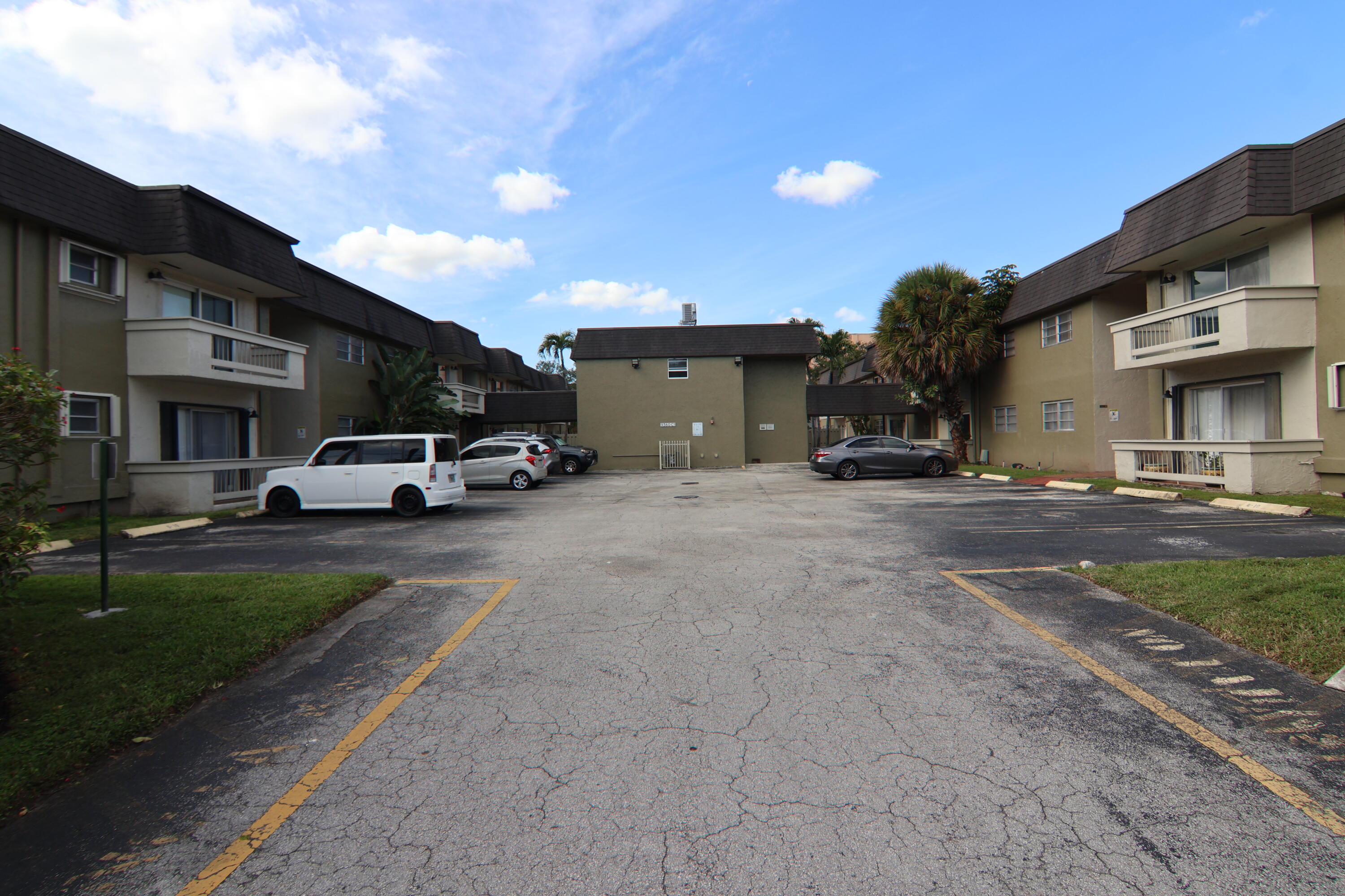 9360 Southwest 87th Avenue, Unit N8 Miami, FL 33176 - Photo 7 of 15 a car parked in front of white building