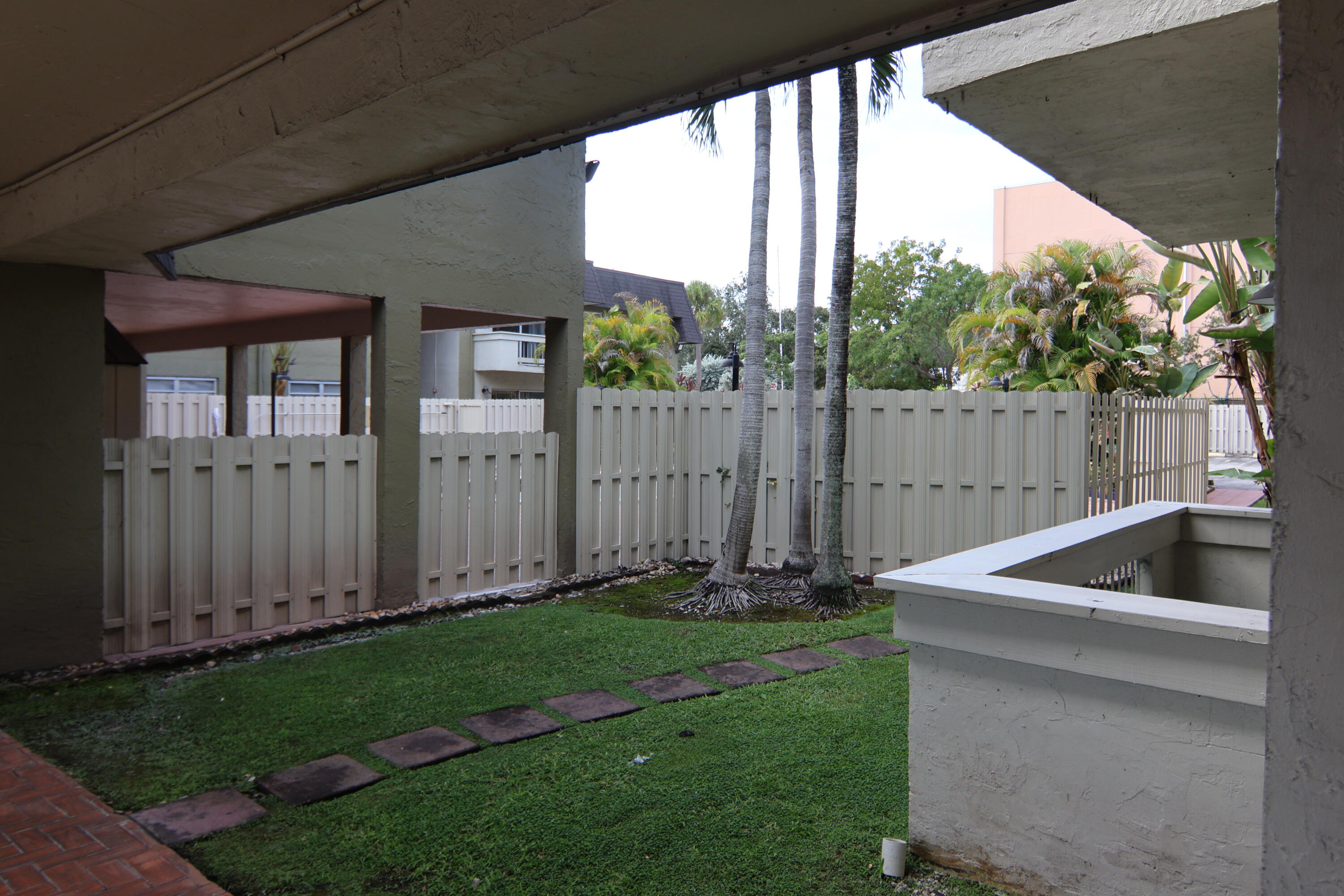 9360 Southwest 87th Avenue, Unit N8 Miami, FL 33176 - Photo 8 of 15 a view of backyard with barbeque grill and wooden fence