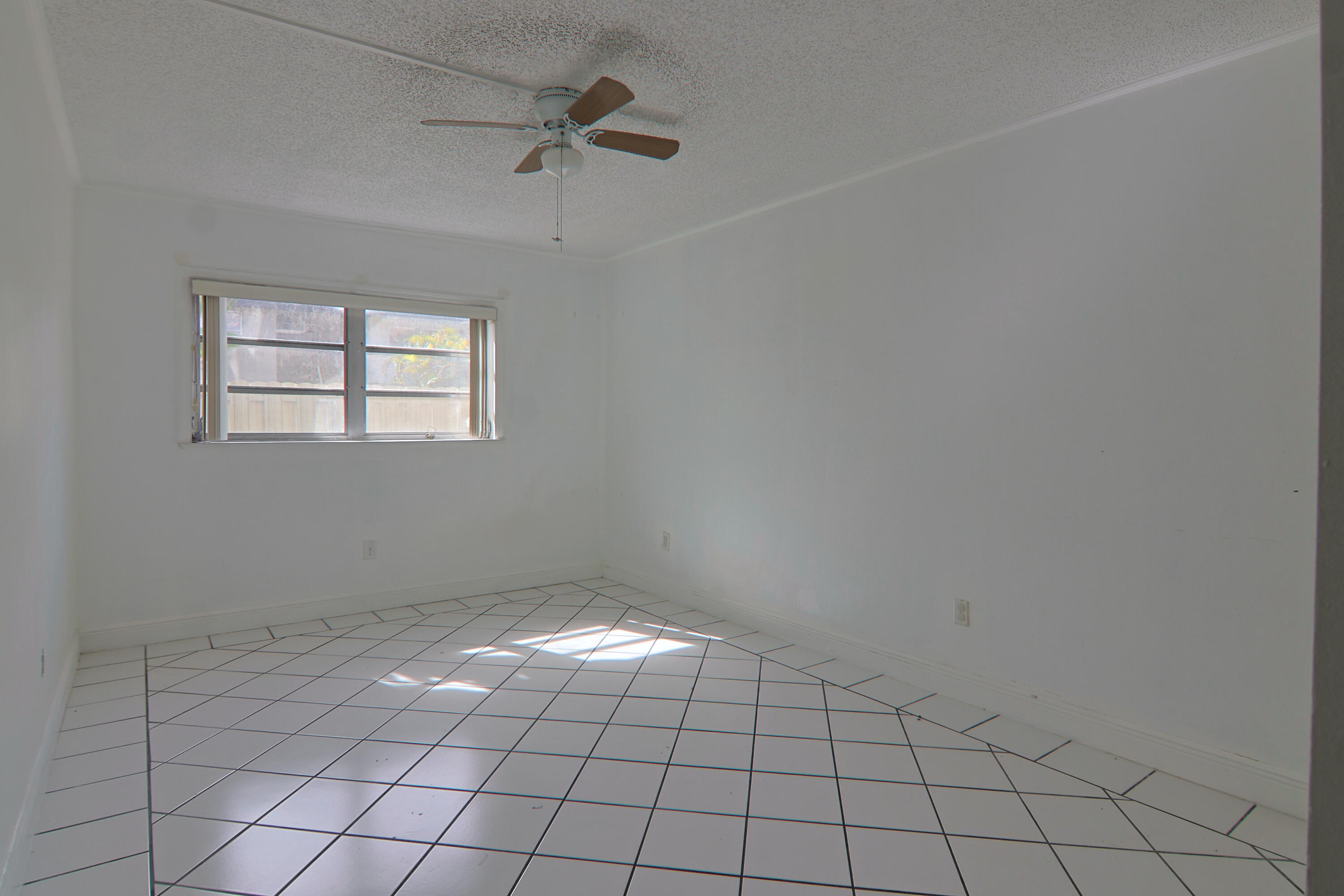9360 Southwest 87th Avenue, Unit N8 Miami, FL 33176 - Photo 9 of 15 a view of an empty room with window