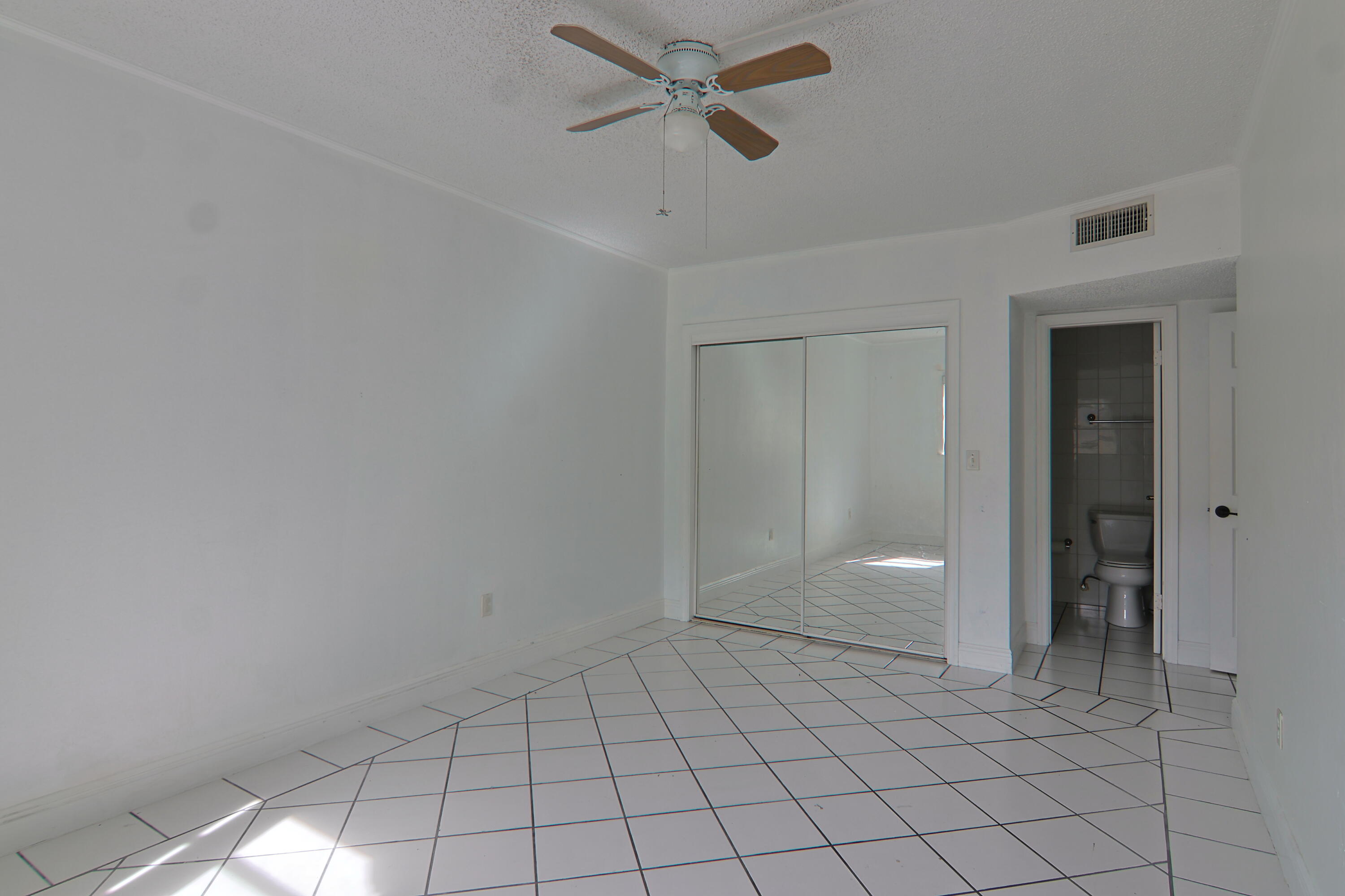9360 Southwest 87th Avenue, Unit N8 Miami, FL 33176 - Photo 10 of 15 an empty room with closet and a chandelier fan