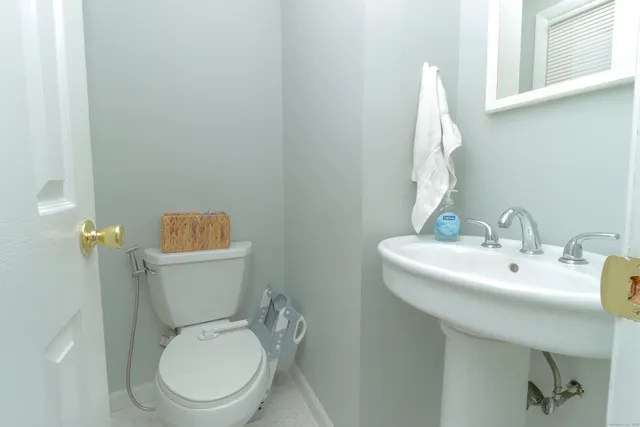 a white toilet sitting next to a bathroom sink