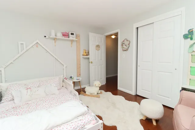 a bedroom with a bed and a dresser