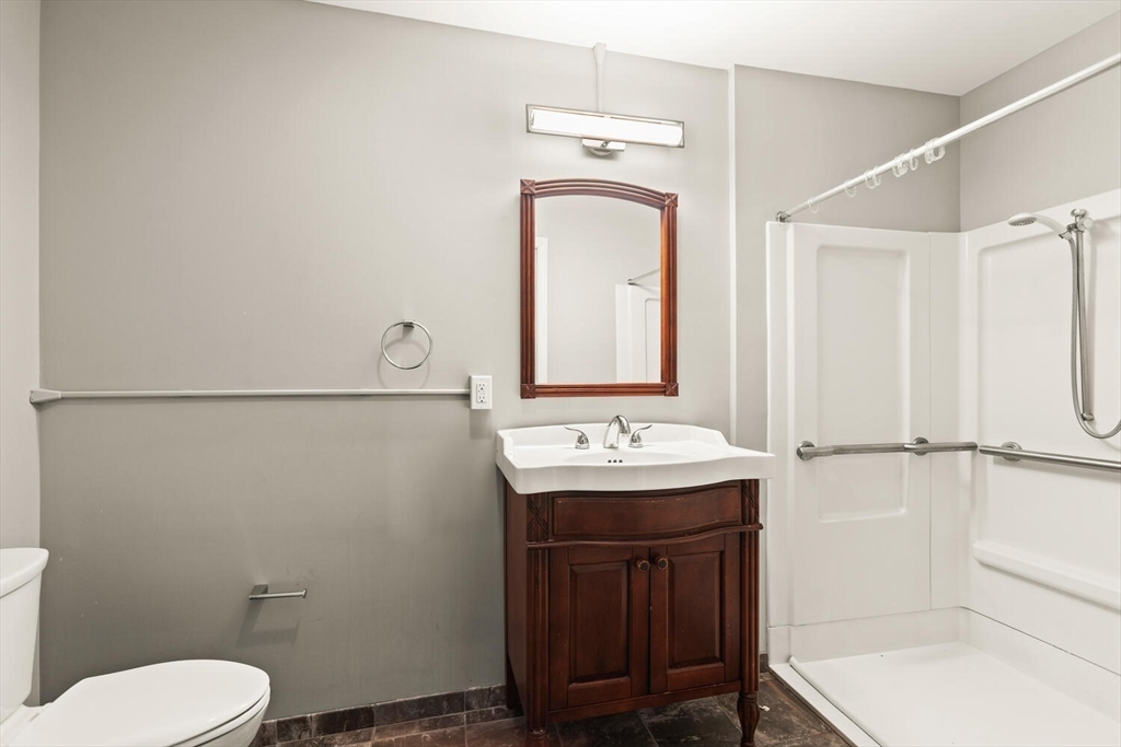 44 Winter Street, Unit 202 Boston, MA 02111 - Photo 5 of 7 a bathroom with a sink a toilet and mirror