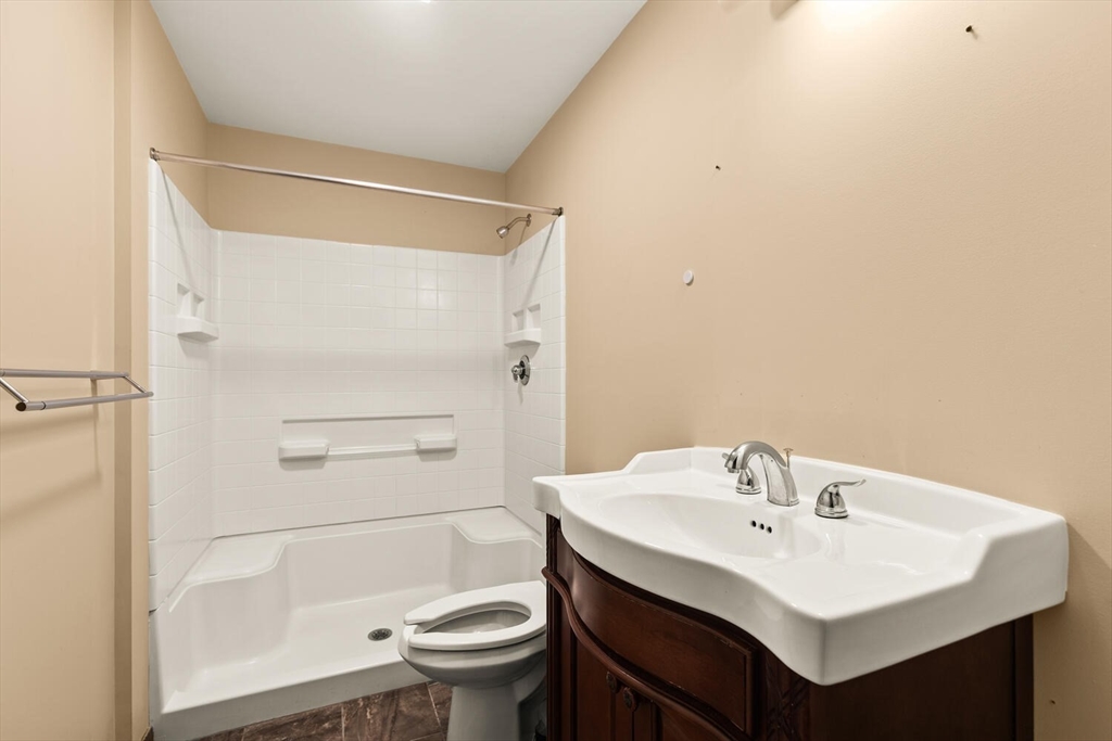 44 Winter Street, Unit 202 Boston, MA 02111 - Photo 6 of 7 a bathroom with a sink toilet and shower
