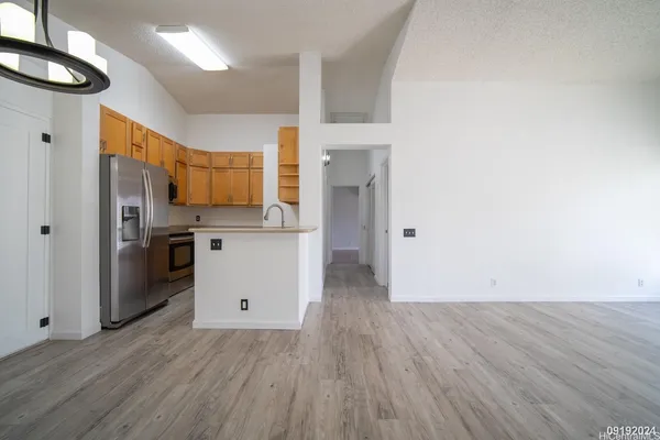 a kitchen with stainless steel appliances a refrigerator and a stove top oven