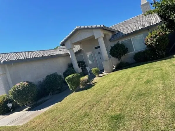 a front view of a house with garden