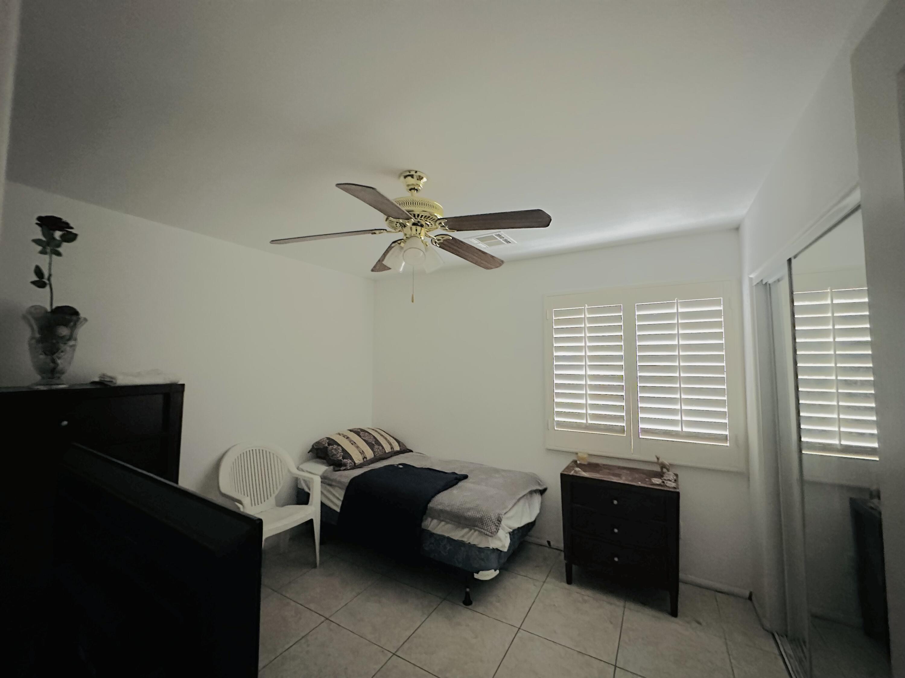 31675 Victor Road Cathedral City, CA 92234 - Photo 11 of 17 a bedroom with a bed and a window