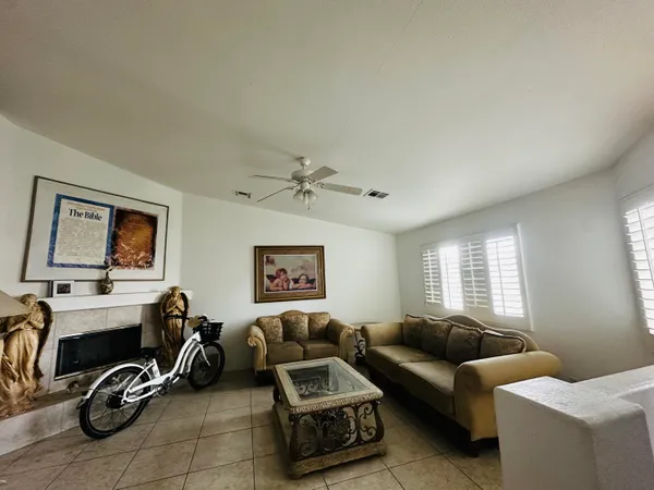 a living room with furniture a couch and a window