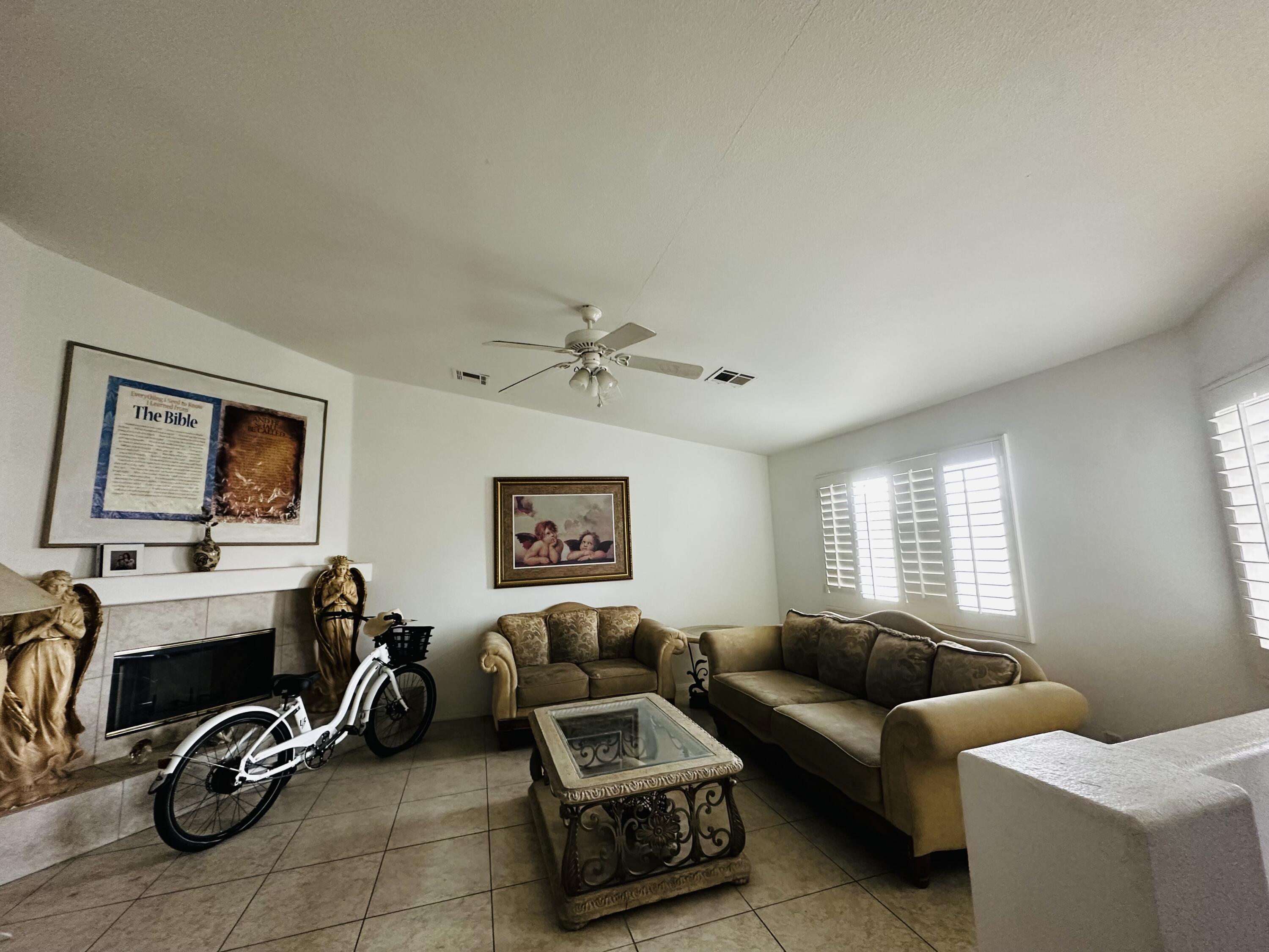 31675 Victor Road Cathedral City, CA 92234 - Photo 14 of 17 a living room with furniture a couch and a window