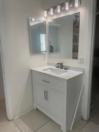 a bathroom with a sink and a mirror