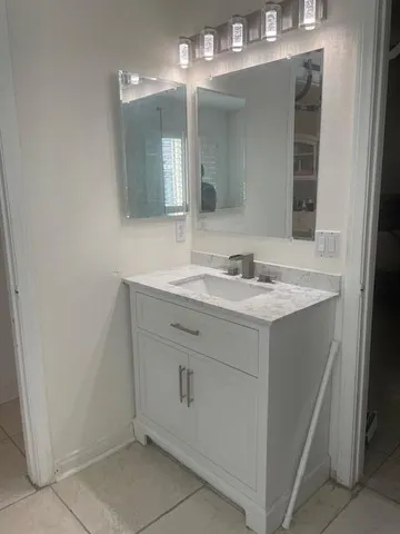 a bathroom with a sink and a mirror