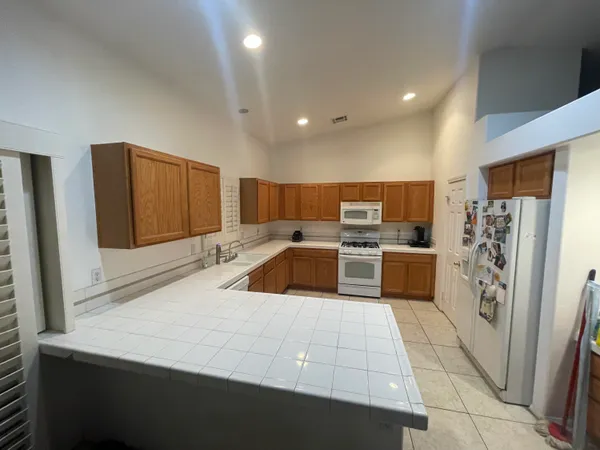 a kitchen with stainless steel appliances a refrigerator and a stove top oven