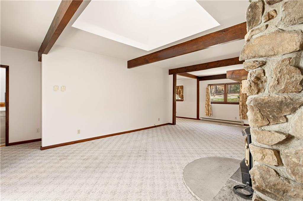 112 Chestnut Ridge Road Acme, PA 15610 - Photo 11 of 31 a view of a room with wooden floor and windows