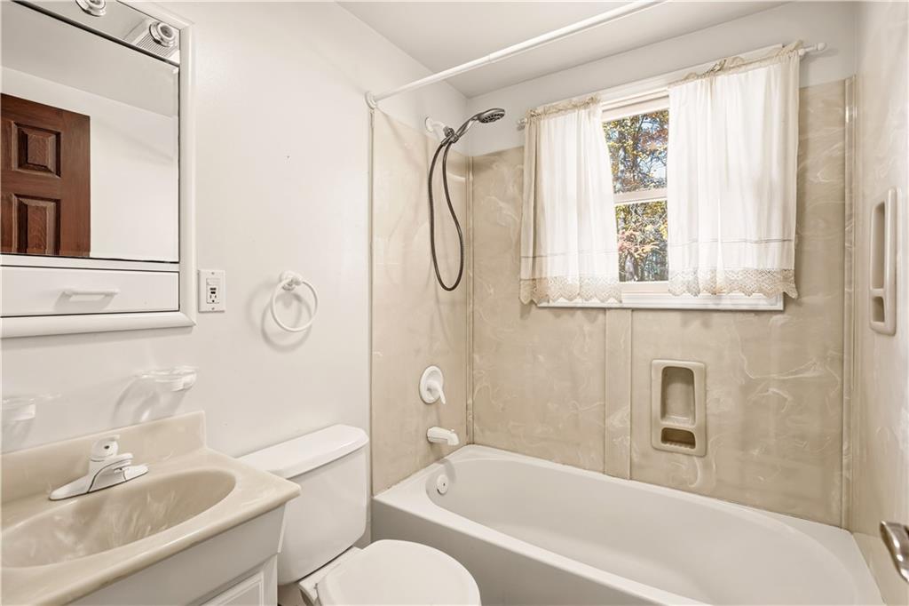 112 Chestnut Ridge Road Acme, PA 15610 - Photo 19 of 31 a bathroom with a granite countertop bathtub shower sink vanity and a toilet