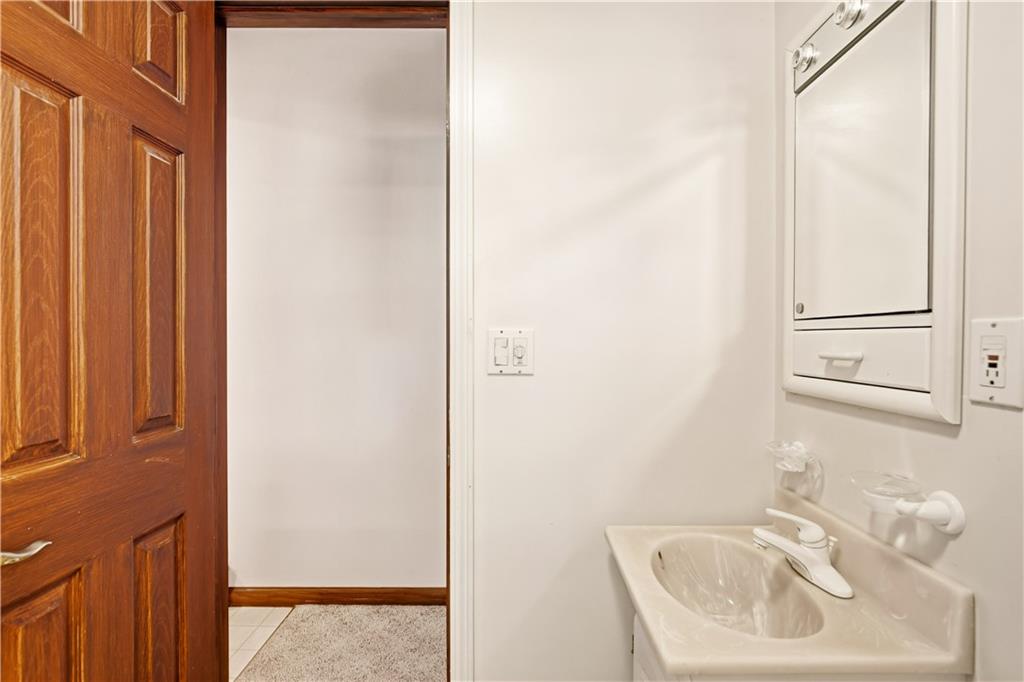 112 Chestnut Ridge Road Acme, PA 15610 - Photo 20 of 31 a bathroom with a sink a mirror and shower