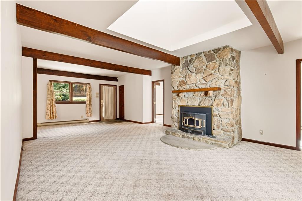 112 Chestnut Ridge Road Acme, PA 15610 - Photo 7 of 31 an empty room with a fireplace and window