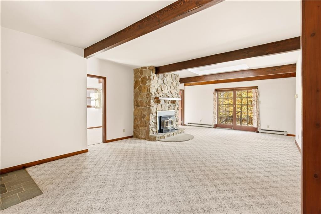 112 Chestnut Ridge Road Acme, PA 15610 - Photo 9 of 31 a view of an empty room with a fireplace
