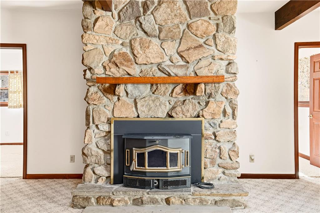 112 Chestnut Ridge Road Acme, PA 15610 - Photo 10 of 31 a stone fireplace with a wooden floor