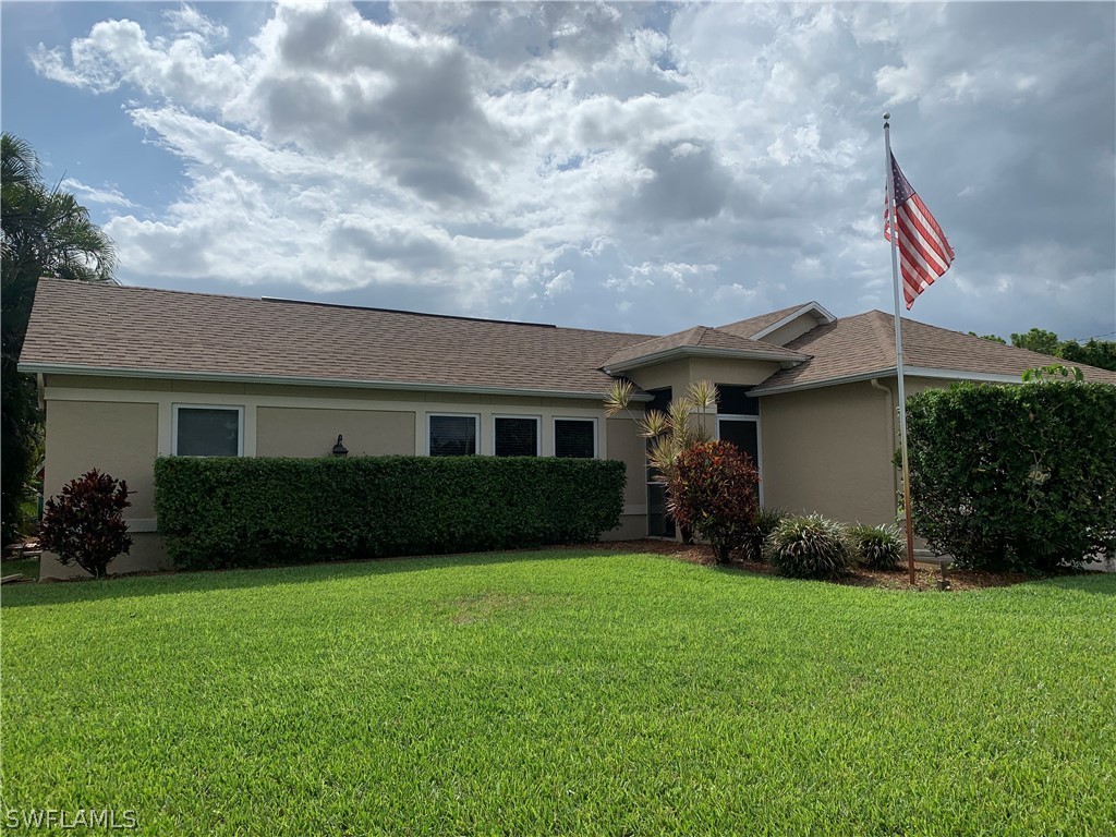 17560 Lee Road Fort Myers, FL 33967 - Photo 1 of 34 a front view of a house with garden