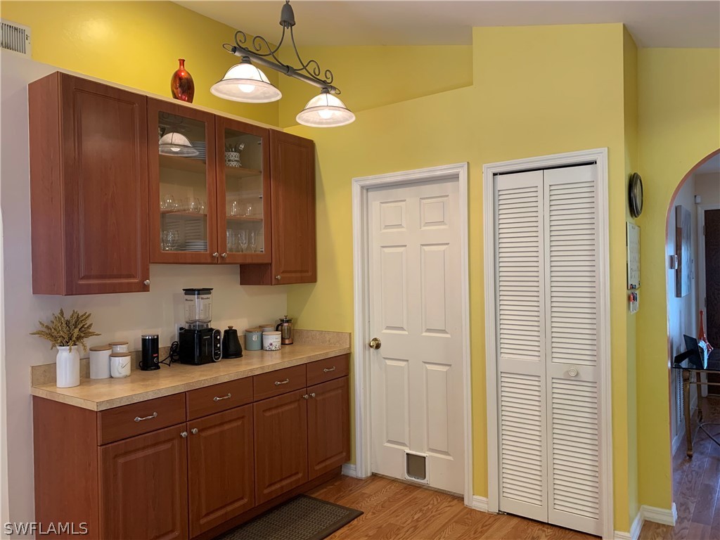 17560 Lee Road Fort Myers, FL 33967 - Photo 11 of 34 a kitchen with a sink cabinets and wooden floor