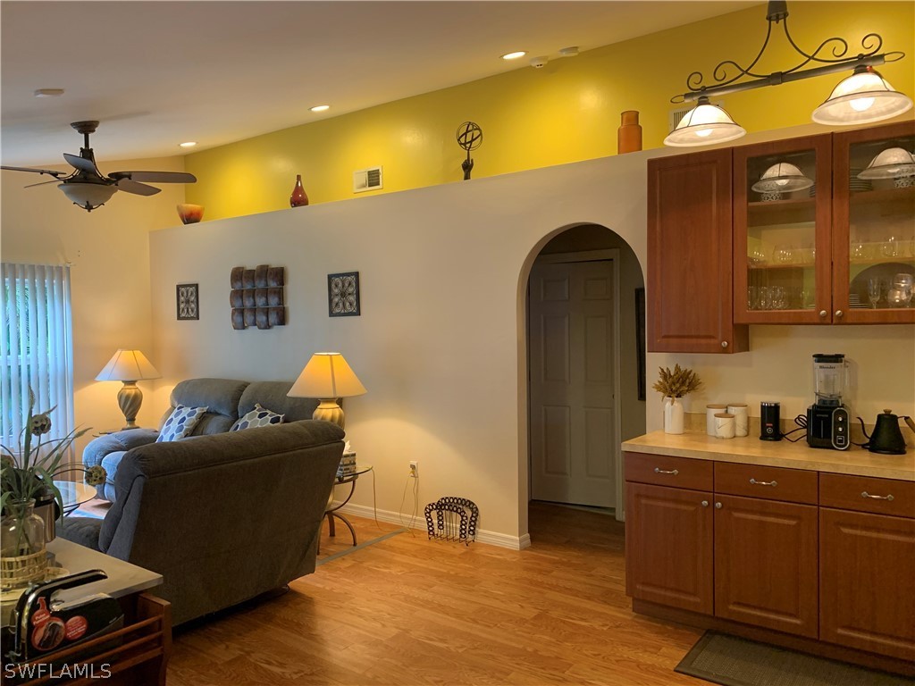 17560 Lee Road Fort Myers, FL 33967 - Photo 12 of 34 a living room with furniture and a chandelier