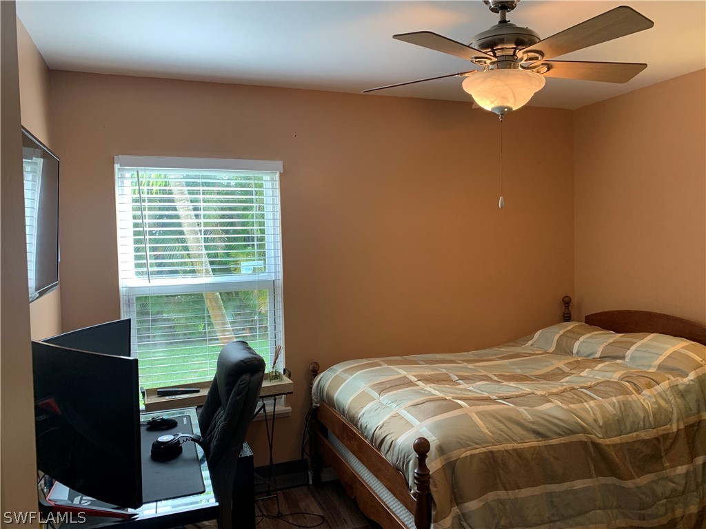 17560 Lee Road Fort Myers, FL 33967 - Photo 18 of 34 a bedroom with a bed and a desk