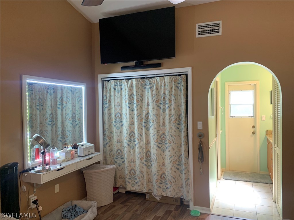 17560 Lee Road Fort Myers, FL 33967 - Photo 19 of 34 a view of a livingroom with wooden floor and a flat screen tv