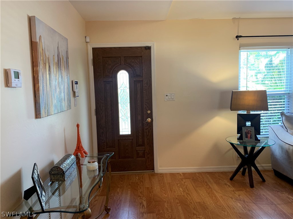 17560 Lee Road Fort Myers, FL 33967 - Photo 2 of 34 a view of a workspace room with wooden floor windows and chair