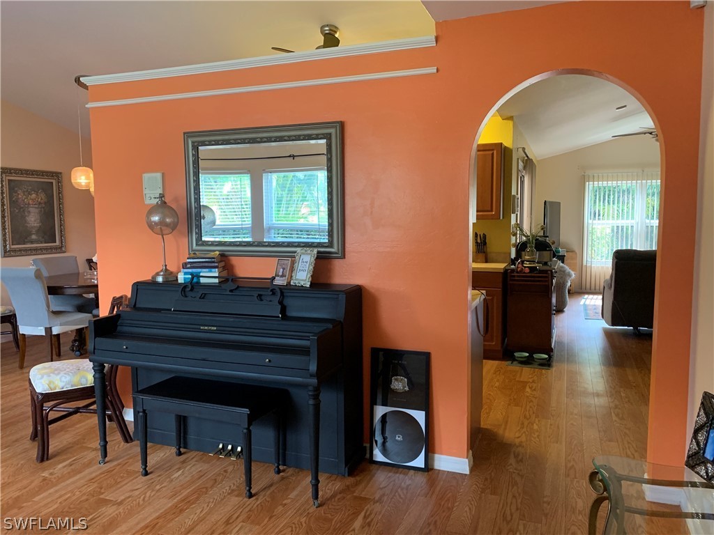 17560 Lee Road Fort Myers, FL 33967 - Photo 3 of 34 a room with furniture and a wooden floor