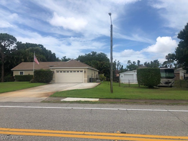 17560 Lee Road Fort Myers, FL 33967 - Photo 31 of 34 a view of a house with a yard and a garden