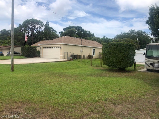 17560 Lee Road Fort Myers, FL 33967 - Photo 33 of 34 a view of a white house with a big yard and a large tree