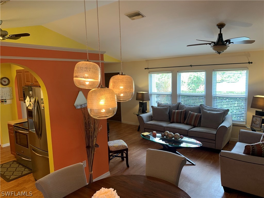 17560 Lee Road Fort Myers, FL 33967 - Photo 7 of 34 a living room with furniture a chandelier and a window