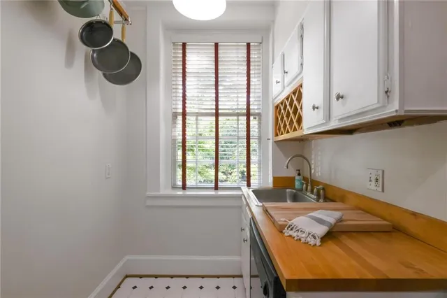 a bathroom with a granite countertop sink and a window