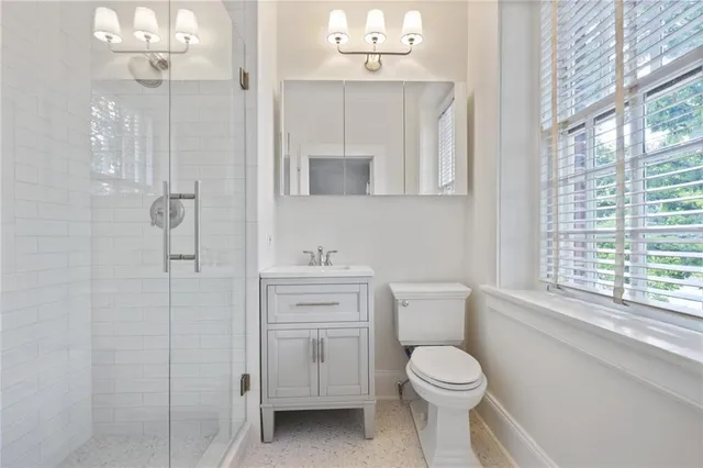 a bathroom with a toilet sink and shower