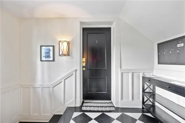 a view of a hallway with entryway and stairs