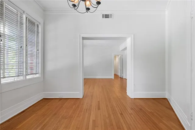 a view of a room with wooden floor and window