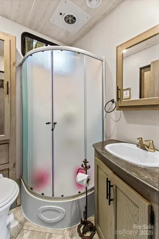 a bathroom with a granite countertop sink a toilet and a mirror