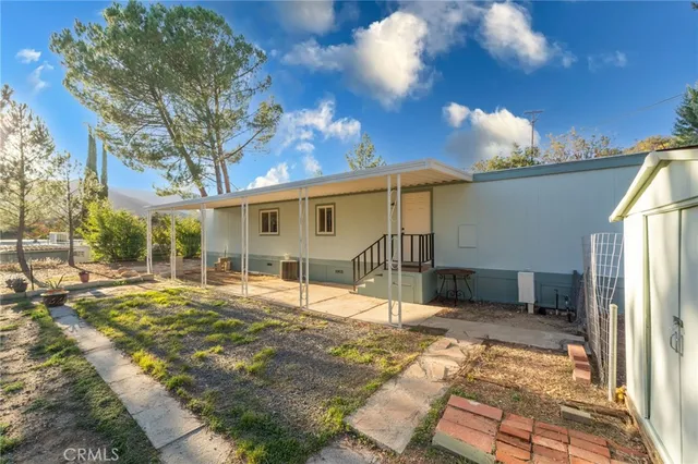 a view of a porch with furniture and a backyard