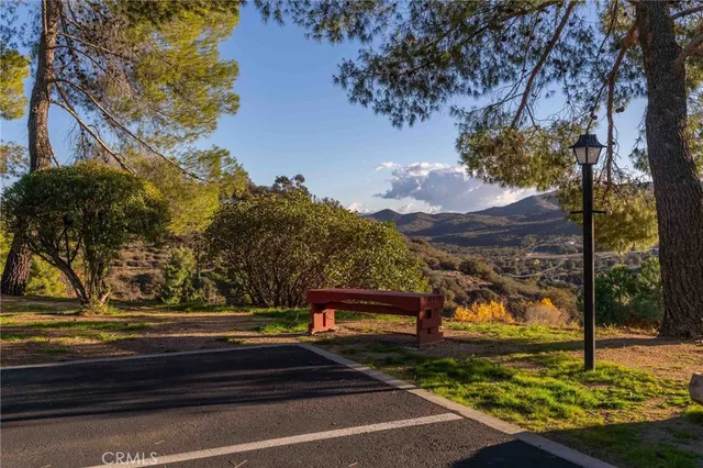 a view of a patio with a table and chairs under an umbrella