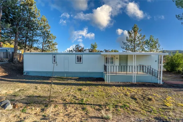 a view of a kitchen with furniture and wooden floor