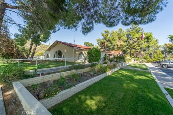 an aerial view of a house with a yard and street view