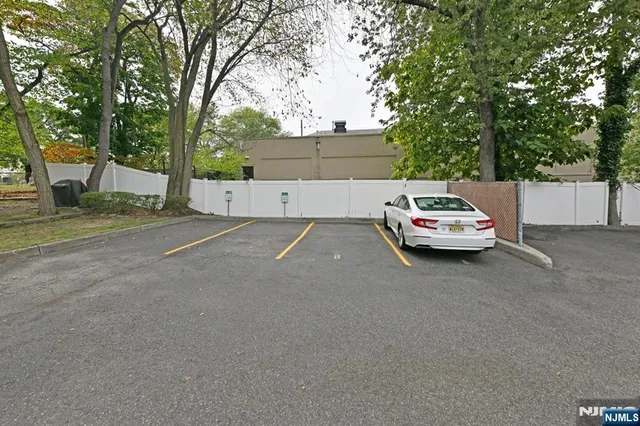 a view of a city street with large trees