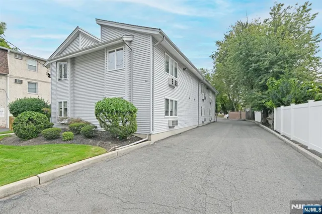 a view of a house with a yard and garage