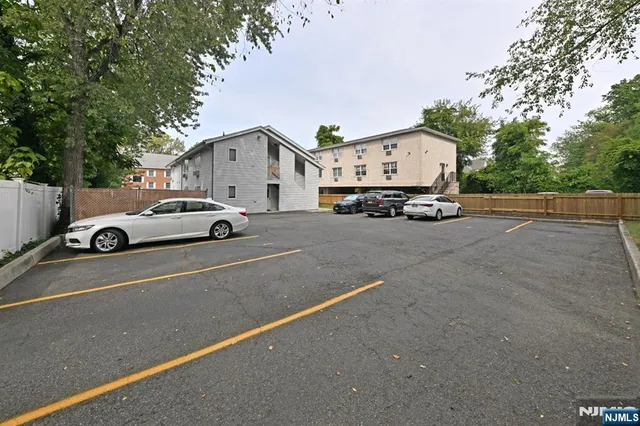 a car parked in front of white house