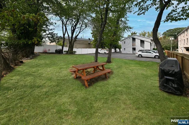 a car parked in the grass near a tree