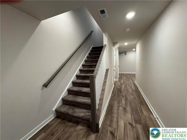 a view of entryway and hall with wooden floor