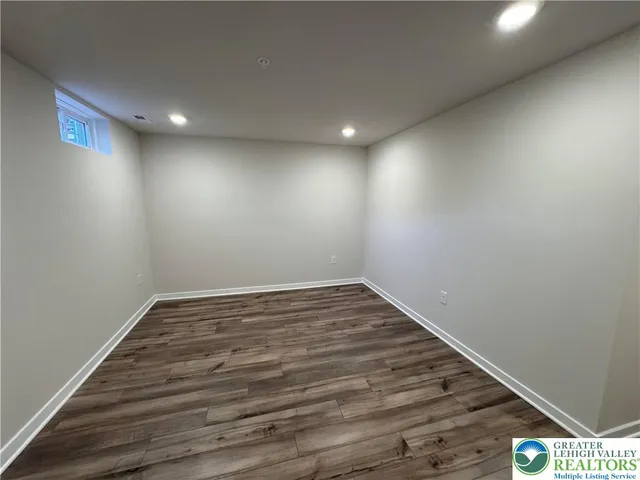 a view of a room with wooden floor